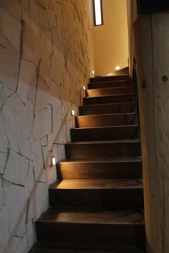 a staircase in a building with a stone wall at Casa Cairo Pátzcuaro in Pátzcuaro