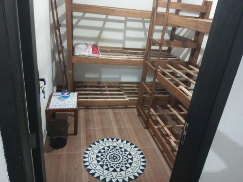 a room with two bunk beds and a wooden floor at B & B Hostels Balneário in Balneário Camboriú