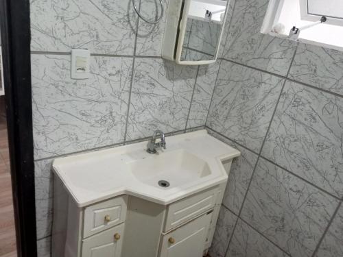 a bathroom with a sink and a mirror at B & B Hostels Balneário in Balneário Camboriú