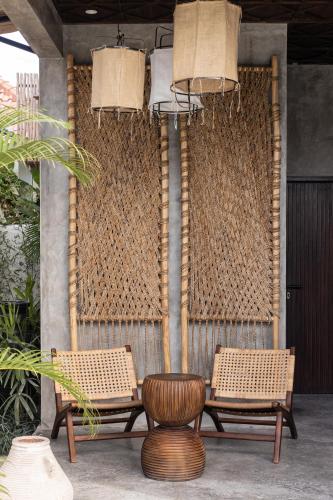 two chairs and a table on a patio at Kano Twin in Canggu