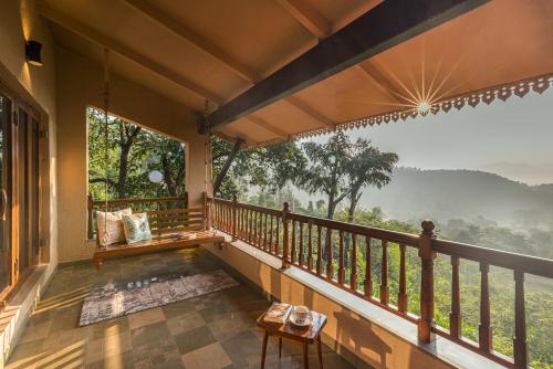 a balcony of a house with a view at SaffronStays Sunkissed - 2 Bedroom Infinity Pool Villa in Mulshi in Mulshi