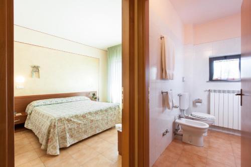Postel nebo postele na pokoji v ubytování Hotel Fabbrini