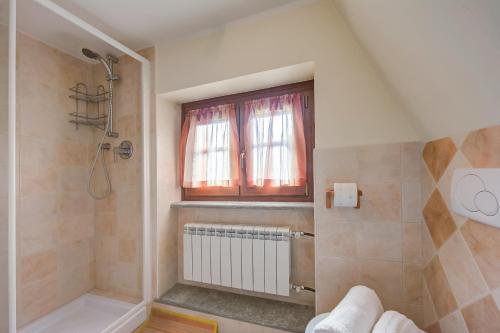 a bathroom with a shower and a window at Studio Placide Mountain View - Happy Rentals in Sauze dʼOulx