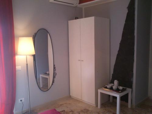 a room with a white cabinet and a mirror at Cartoline Dall'Etna B&b in Zafferana Etnea