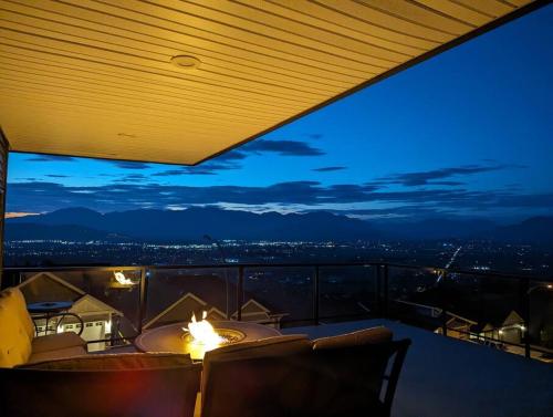 a room with a view of the city at night at A Mountain Retreat with Views, Hot Tub & AC in Chilliwack