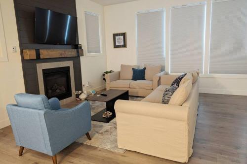 a living room with a couch and a fireplace at Mountain Retreat with Views, Hot Tub, Games & AC in Chilliwack