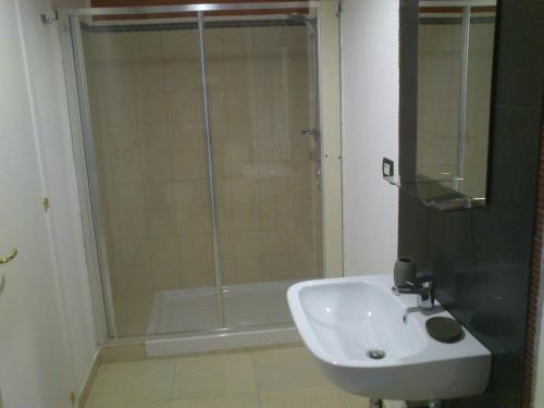 a bathroom with a shower and a sink at Cartoline Dall'Etna B&b in Zafferana Etnea