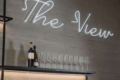 a sign that says the new way with wine glasses at Almond Hotel - Adults only in Neve Ilan
