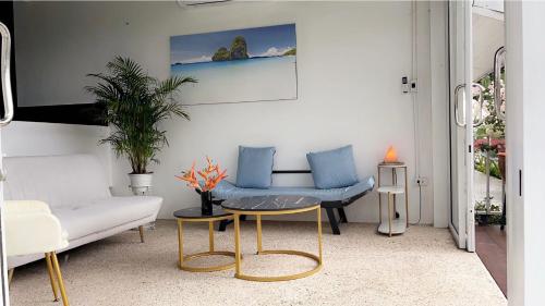 a living room with a couch and a table at White Seaview Residence in Klong Muang Beach