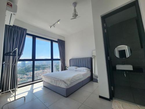 a bedroom with a bed and a large window at Urban Suite - George Town in Jelutong