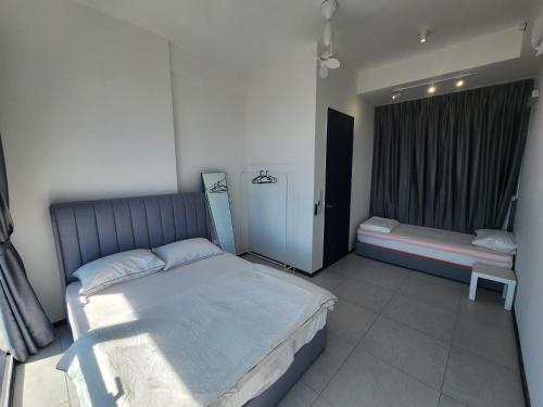 a bedroom with a large bed and a window at Urban Suite - George Town in Jelutong
