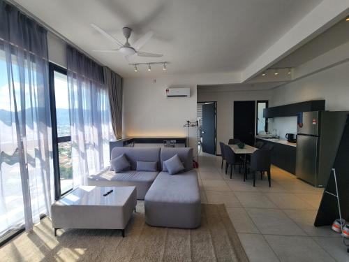 a living room with a couch and a table at Urban Suite - George Town in Jelutong