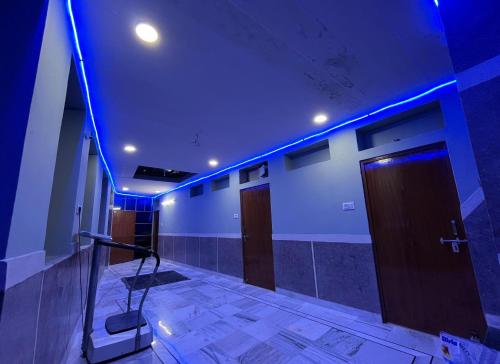 a room with blue lights on the walls and doors at MOON NIGHT GUEST HOUSE in Jodhpur