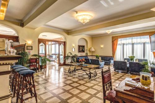 a large living room with chairs and a table at Villa Romita in SantʼAgata sui Due Golfi