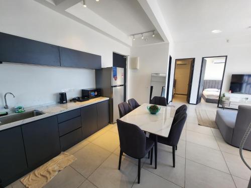 a kitchen and dining room with a table and chairs at Urban Suites - Penang in Jelutong