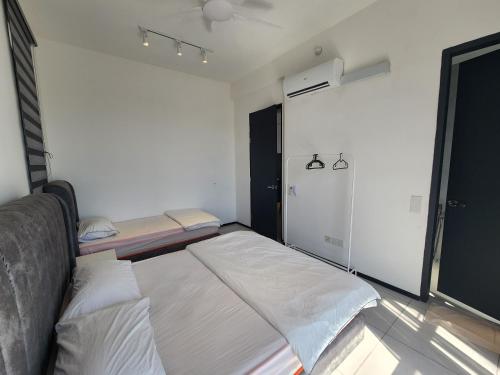 a small bedroom with a bed and a closet at Executive Premium Urban Suites - Jelutong in Jelutong
