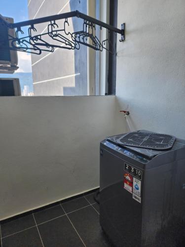 a trash can in a room with a window at Executive Premium Urban Suites - Jelutong in Jelutong