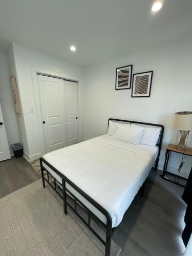a large bed in a room with a white wall at Mary's Stay Petworth in Washington, D.C.