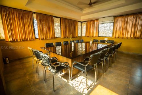 a conference room with a long table and chairs at Oak Field Inn in Cochin