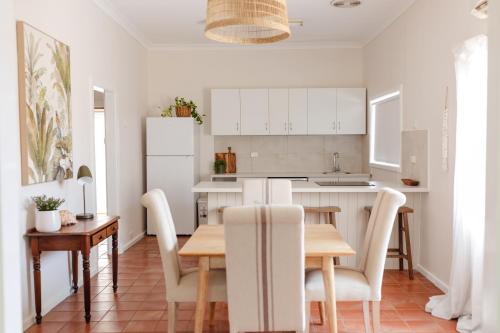 a kitchen and dining room with a table and chairs at Pet Friendly Family Home in Bluff Point in Geraldton