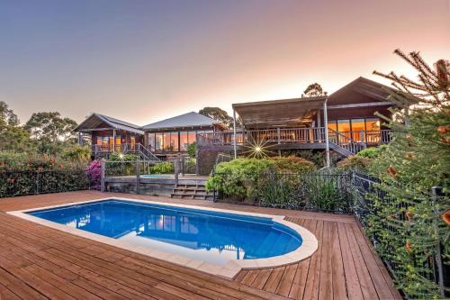 a house with a swimming pool on a wooden deck at Main Break in Dunsborough