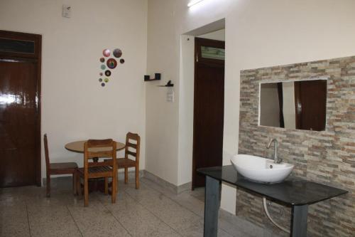 a bathroom with a sink and a table at Shiva INN in Varanasi