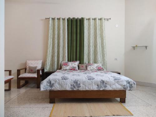 a bedroom with a bed and a green curtain at Shiva INN in Varanasi