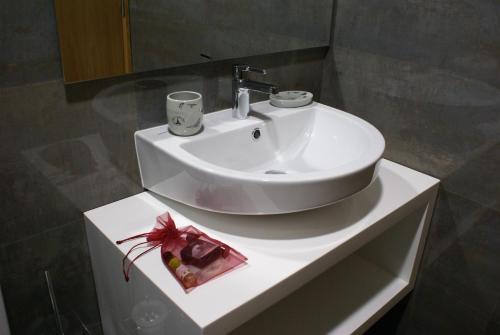 a white sink in a bathroom with a mirror at Casa Da Trigueira in Santa Eugénia