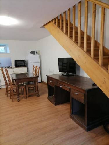 a living room with a desk and a staircase at Le Relais de Garabit in Anglards-de-Saint-Flour