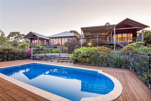 a house with a swimming pool in front of a house at Main Break in Dunsborough