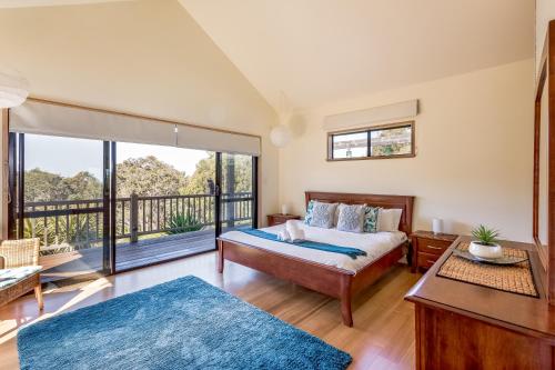 a bedroom with a bed and a balcony at Main Break in Dunsborough