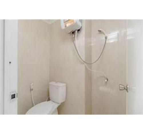 a bathroom with a shower and a toilet and a shower at OYO Life 93374 Andira Inn in Depok