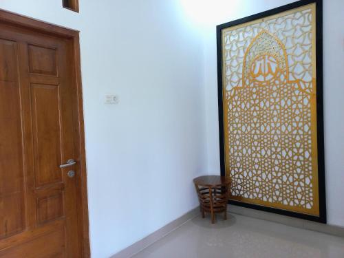 a door to a room with a painting on the wall at Homestay Jogja Prambanan By Simply Homy in Sleman
