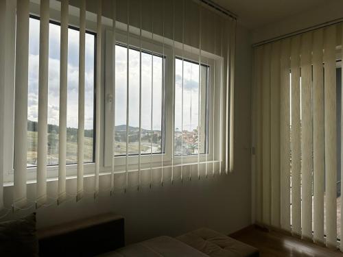 a room with two large windows with white blinds at Gondola Mako Exclusive in Zlatibor