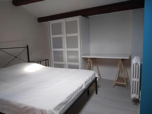 a bedroom with a white bed and a desk at SeaHarbour Pesaro in Pesaro