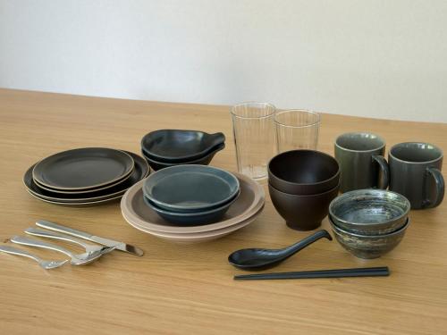 a table with black plates and utensils on it at Rakuten STAY VILLA Nikko in Nikko