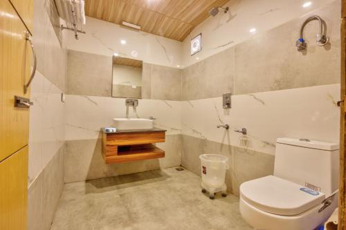 a bathroom with a toilet and a sink at The Shivalaya Retreat - A River Side Resort in Jagatsukh