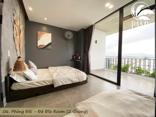 a bedroom with a bed and a balcony at PAMY Homestay Phú Yên in Phu Yen