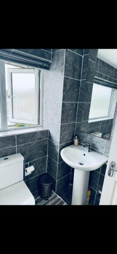 a bathroom with a white sink and a toilet at Master room in Bristol