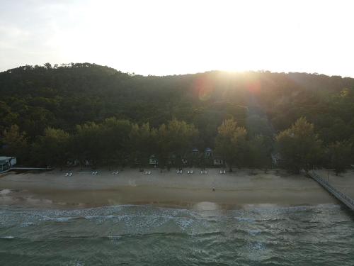a beach with a group of people on the shore at Sandy Beach Bungalows By EHM in Koh Rong Sanloem