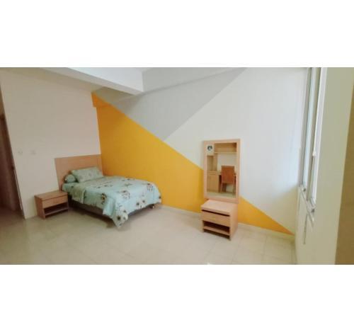 een kleine slaapkamer met een bed en een kast bij OYO Life 93383 Wisma Kencana Puteri in Depok