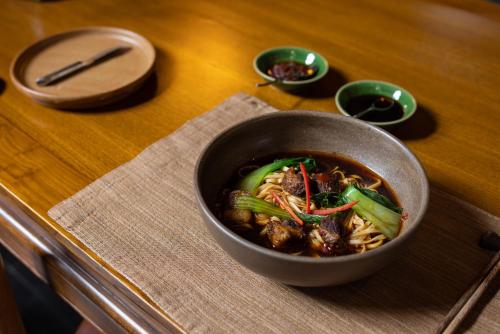 a bowl of food sitting on a table at Jing's Residence Pingyao in Pingyao