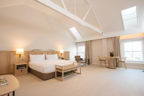 a hotel room with a bed and a table at COMO The Treasury in Perth