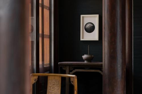 a room with a table with a bowl on it at Jing's Residence Pingyao in Pingyao