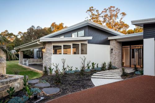 a house with a gray and white at It's Five O'Clock Somewhere I Private Properties in Yallingup