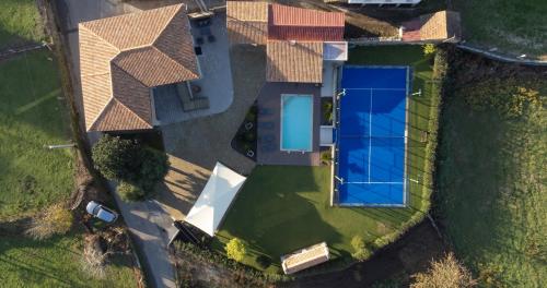 an overhead view of a house with a solar roof at Casa Grande Gondomil com Campo de Padel, Piscina in Valença