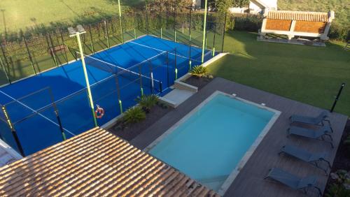 an overhead view of a swimming pool in a backyard at Casa Grande Gondomil com Campo de Padel, Piscina in Valença