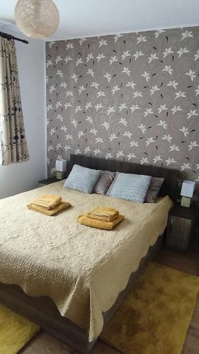 a bedroom with a bed with two towels on it at Rooftop View in Predeluţ