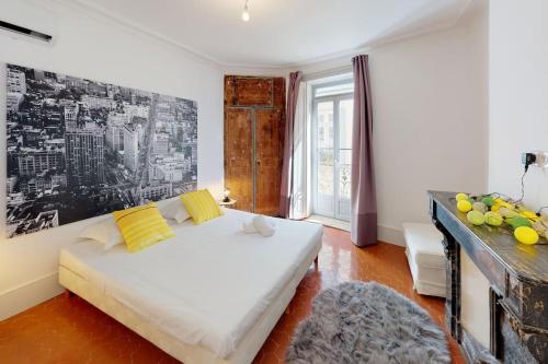 a bedroom with a white bed and a large window at Mas Saint Côme - Superbe appartement 4 chambres Centre Historique in Montpellier