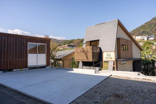 a house with a driveway in front of a building at HAKO REIRO 箱・玲瓏 in Hakone